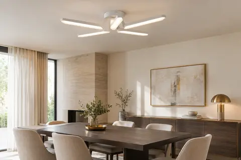Plafonnier blanc à cinq branches en V, installé au plafond d’une salle à manger contemporaine